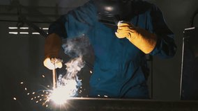 Metal welder working with arc welding machine to weld steel at factory while wearing safety equipment. Metalwork manufacturing and construction maintenance service by manual skill labor concept. - Powered by Shutterstock - Get 15% off with code: PIKWIZARD15
