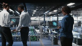 System administrators in data center monitoring AI LLM visualization. African american server farm coworkers overseeing rigs powering machine learning processes, camera A - Powered by Shutterstock - Get 15% off with code: PIKWIZARD15