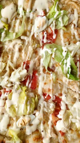 Italian caesar pizza with cheese and chicken, lettuce leaves and sauce. Fast food, sliced pizza