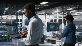 Server hub teamworking IT experts visualizing large language model architecture using notebook. Data center system administrators on industrial platform collaborating on tasks using laptop - Powered by Shutterstock - Get 15% off with code: PIKWIZARD15