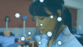 Female doctor tapping tablet initiating floating hex medical icons and monitoring patient status. Healthcare, telemedicine, digital health, collaboration, futuristic, clinical, innovative - Powered by Shutterstock - Get 15% off with code: PIKWIZARD15