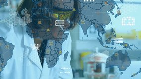Upon world map overlay fading in research scientist leaning over bench monitoring health data icons. Scientist, laboratory, data visualization, global network, scientific research, analytical, - Powered by Shutterstock - Get 15% off with code: PIKWIZARD15