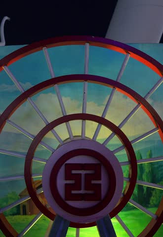 A close-up shot capturing the rotation and structure of a small Ferris wheel. Nanchang, China.