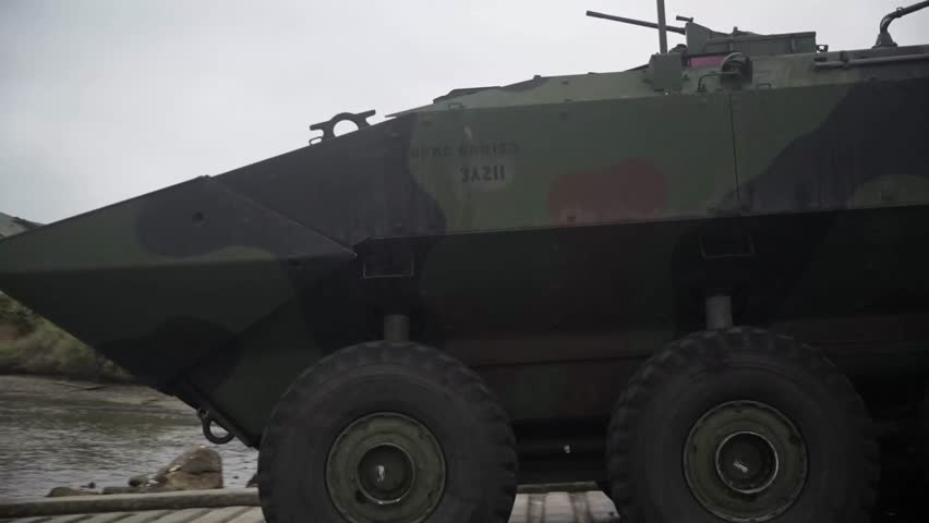 U.S. Marine amphibious combat vehicles transit open waters.
