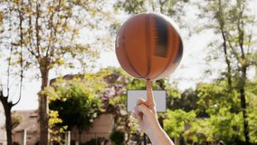 Atmospheric backlit light sillhouette guy spinning basketball on one finger outdoor. Skilled sportsman playing game. Active sport healthy lifestyle. Concept outside activity. Summer vibe warm weather - Powered by Shutterstock - Get 15% off with code: PIKWIZARD15