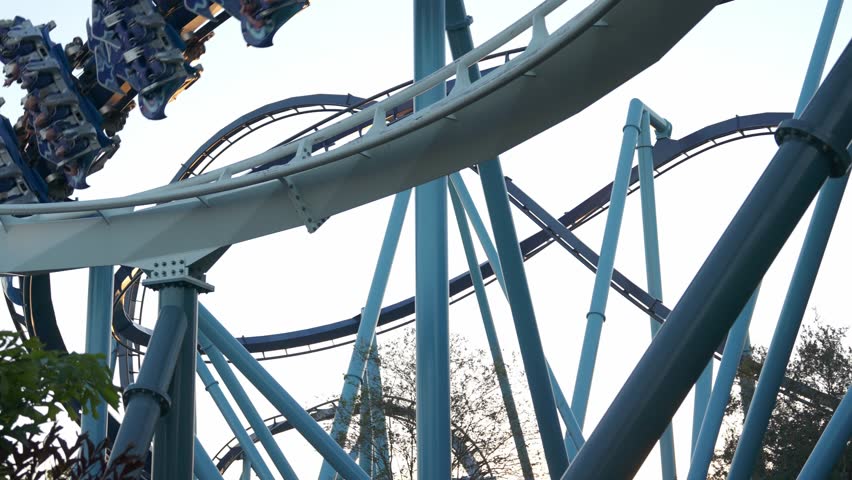 Experience the thrill of a roller coaster ride at amusement park as the sunset. Enjoy the excitement of steep drops and sharp turns while surrounded by vibrant scenery and fellow riders.