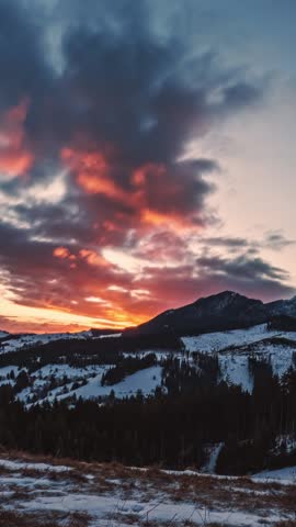 Vertical Timelapse of Colorful Clouds Sky Moving Fast Over Winter Landscape at Twilight