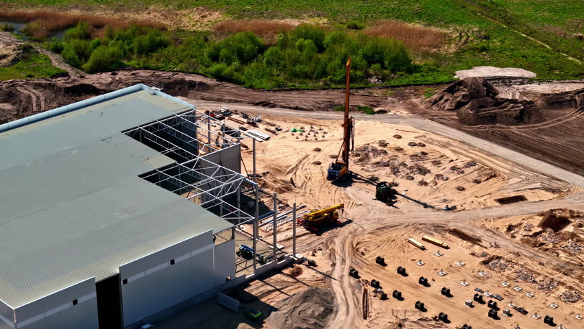 Warehouse under construction building site industrial hall factory, aerial drone view