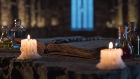 Melted candles, potion bottles and ancient book with magic wand on stone altar in mystical medieval castle, with moonlight streaming through window and magical atmosphere evoking fantasy. - Powered by Shutterstock - Get 15% off with code: PIKWIZARD15