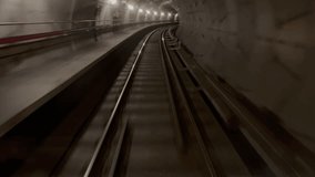 Dark underground train in motion through tunnel with tracks leading into the distance, captured from a moving subway perspective - Powered by Shutterstock - Get 15% off with code: PIKWIZARD15