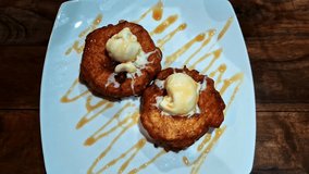 Golden Fried Dough Pastries Topped With Melting Ice Cream And Drizzled With Caramel Sauce. Zoom In - Powered by Shutterstock - Get 15% off with code: PIKWIZARD15