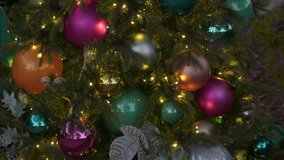 Beautiful Christmas tree is covered in shiny ornaments and glowing lights. A streetlamp glows in the background during twilight. - Powered by Shutterstock - Get 15% off with code: PIKWIZARD15