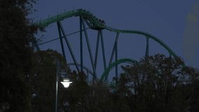 Experience the excitement of a thrilling amusement ride at Adventure Park as the sun sets. The roller coaster looms against the evening sky, ready to take riders on a wild adventure. - Powered by Shutterstock - Get 15% off with code: PIKWIZARD15