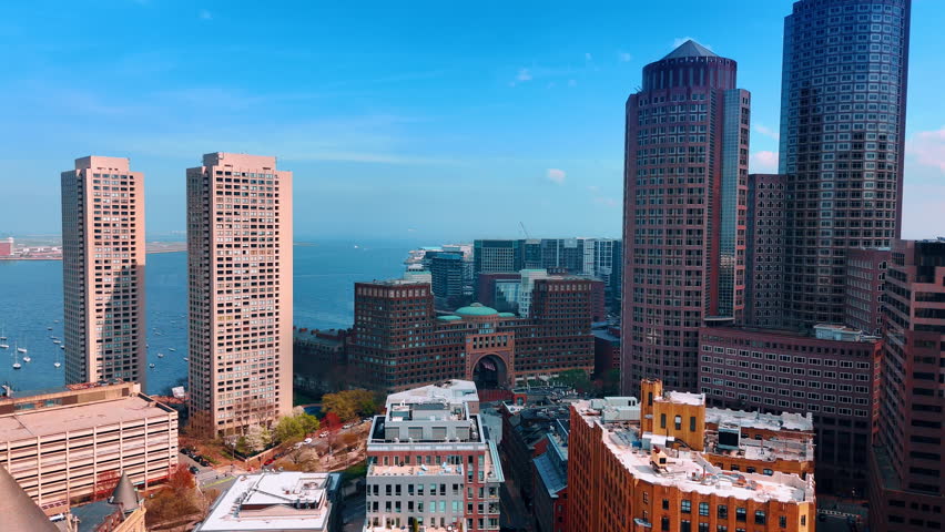 Boston downtown financial at the backdrop of blue waterscape. Sailboats on the Charles river at backdrop. Aerial perspective.