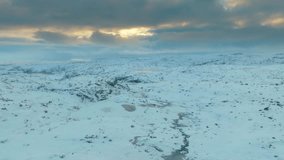 Winter drone view of frozen lake and surrounding snowy tundra at Musta - Tunturi Ridge, part of the remote Kola Peninsula in Arctic Russia. - Powered by Shutterstock - Get 15% off with code: PIKWIZARD15