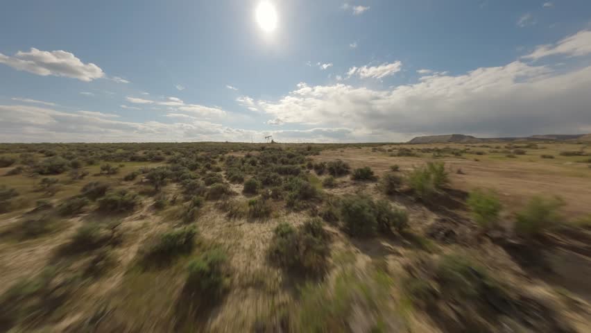 FPV Drone Shot Flying Through Desert Sagebrush, Flying Through Pumping Oil Rig, and Tracking White Truck with Golden Retriever – Aerial Landscape