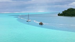 Drone Tahiti. Aerial view of Huahine island lagoon, palm trees and mountains, clear ocean water in French Polynesia. Exotic travel, romantic honeymoon destination in French Polynesia.  - Powered by Shutterstock - Get 15% off with code: PIKWIZARD15