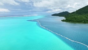 Drone Tahiti. Aerial view of Huahine island lagoon, palm trees and mountains, clear ocean water in French Polynesia. Exotic travel, romantic honeymoon destination in French Polynesia.  - Powered by Shutterstock - Get 15% off with code: PIKWIZARD15