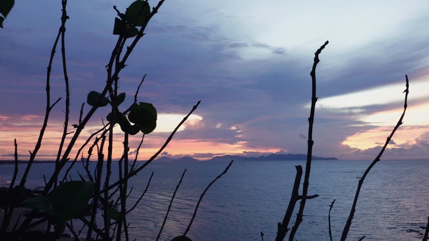 Vung Tau, Vietnam- May 27, 2025: A peaceful view of the ocean at sunset with vibrant orange and purple clouds over calm water. Taken from the coast of Vietnam.