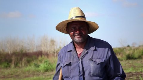 GUINES, CUBA - CIRCA APRIL 2013: Beginning of the growing season, portrait of black peasant with hat in farm, circa April 2013 in Guines, Cuba