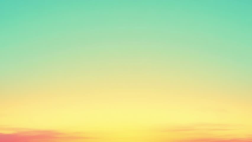Endless loop video of vibrant gradient sky with soft yellow and turquoise hues at sunset over a tranquil horizon for serene background use