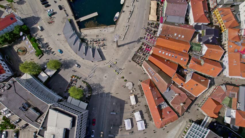 High-altitude overhead drone shot capturing Stavanger Torget and Vågen, highlighting the city’s lively waterfront and urban charm in sunny weather.