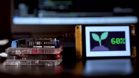 Soil moisture display screen with IoT microcontroller operation, Smart farm agriculture - Powered by Shutterstock - Get 15% off with code: PIKWIZARD15