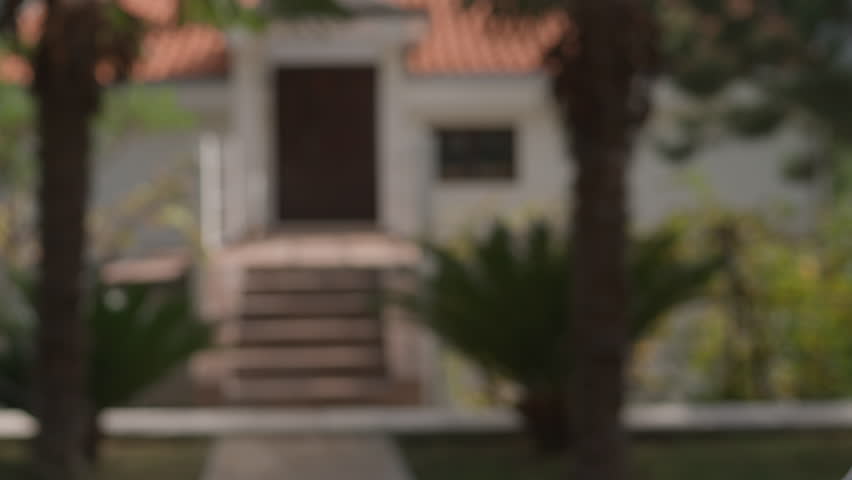 Close up Asian American female hand passing key male outdoors sunlight. Woman handing keys new house man customer. Buying dwelling. Selling home. Real-estate agent job. Handing over keys young couple.