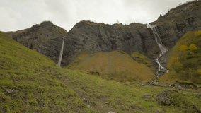 Hiking couple surrounded by magical Batoni Waterfall arena on cloudy day - Powered by Shutterstock - Get 15% off with code: PIKWIZARD15