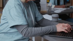 Tilt up shot of diverse volunteers in uniform providing work in food donation center - Powered by Shutterstock - Get 15% off with code: PIKWIZARD15