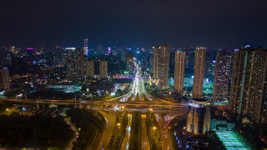 Aerial night timelapse of Hanoi, Vietnam, showing illuminated skyscrapers, vibrant traffic, and glowing city lights. Ideal for urban, travel, and infrastructure themes.