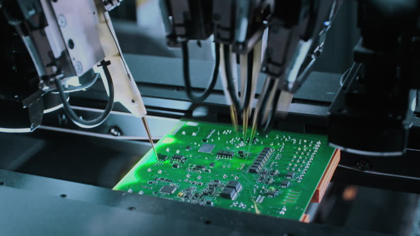 Close-up: machine installs components on circuit board. Electronic devices PCB industry. Factory of graphics processing unit, GPU processor. Production of video cards for artificial intelligence.