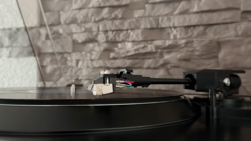 A vinyl record player spinning a record. Smooth sound, vintage style, and retro vibes. Relax and enjoy the analog feel.