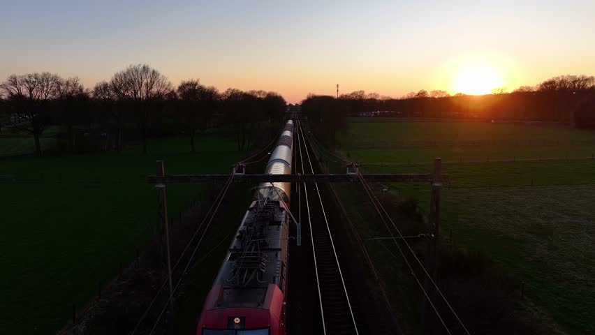 Aerial View: Train on Tracks During Golden Hour Sunset
