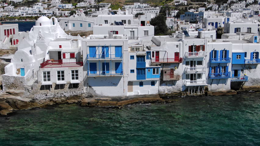 Experience stunning seaside views in Mykonos, where traditional white houses with blue accents highlight the essence of Greek architecture, rich culture, and amazing scenic beauty