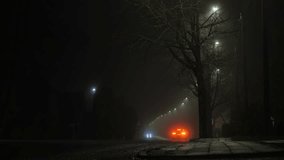 Fog-covered suburban street illuminated by streetlamps with scattered cars - Powered by Shutterstock - Get 15% off with code: PIKWIZARD15