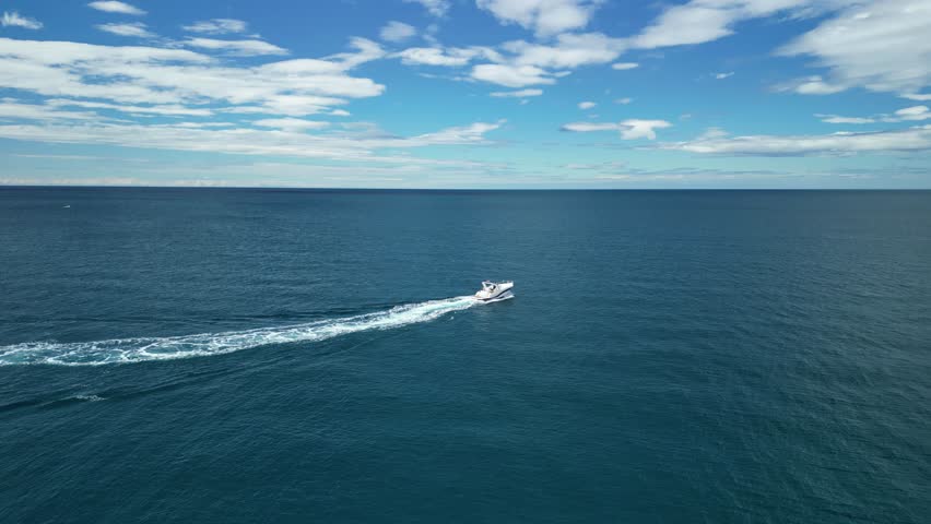 An aerial footage of a boat sailing in the Adriatic Sea off the coast of Pula city in Istrian Peninsula, Croatia on a sunny day
