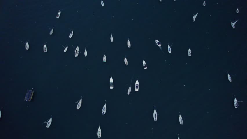 Drone shot of boats scattered near the breakwaters on Lake Michigan, with Chicago