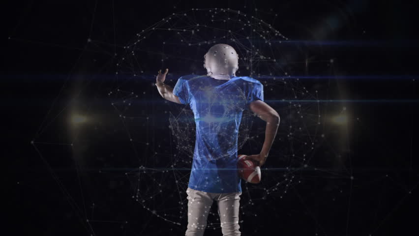 Football player lifting left arm toward holographic network to activate sports technology data. Athlete, technology, futurism, digital, visualization, innovation, virtual - Powered by Shutterstock - Get 15% off with code: PIKWIZARD15