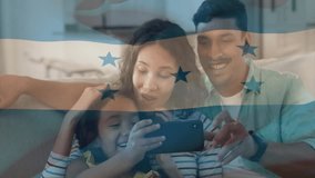 Father tapping smartphone screen and mother supporting daughter exploring tech app on sofa bonding. Family, bonding, technology, leisure, home, connection, happiness - Powered by Shutterstock - Get 15% off with code: PIKWIZARD15