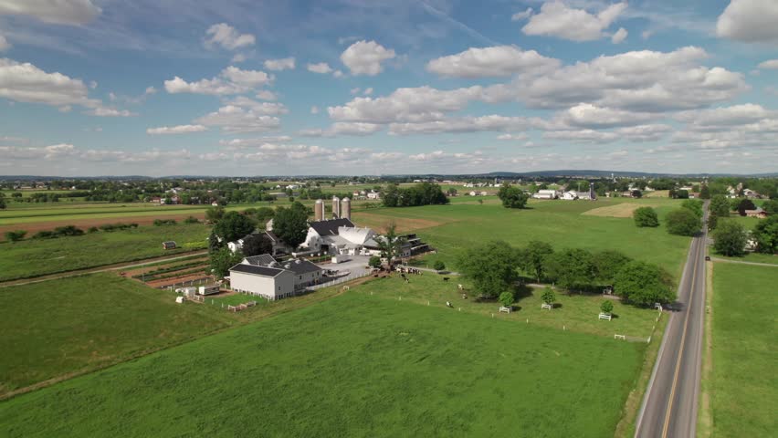Quintessential farm in Pennsylvania Amish country, lush green aerial shot, 4K