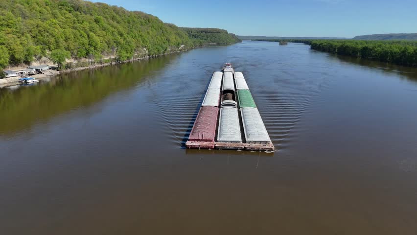 Located along the Mississippi River between Minnesota and Wisconsin's Driftless area, a towboat move a set of barges south.