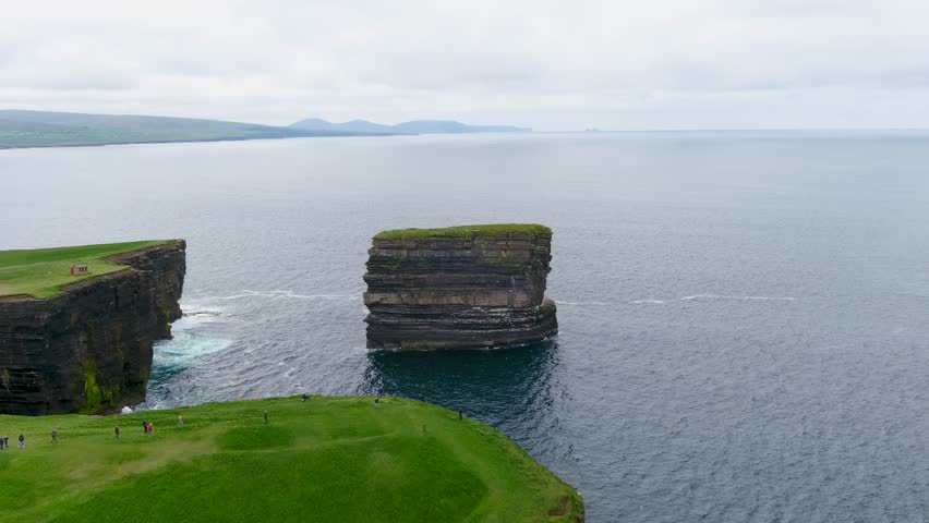 Aerial view of stunning Downpatrick Head coastal landmark with iconic Dun Briste sea stack. Dramatic cliffs and waves. Raw beauty of Ireland's west coast. Wild Atlantic Way Signature Discovery Point.