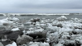 Coastal scene of an icy, rugged shoreline with sea waves crashing in the background. Captures the stark contrast between frozen ice formations and the dynamic ocean waves.
 - Powered by Shutterstock - Get 15% off with code: PIKWIZARD15