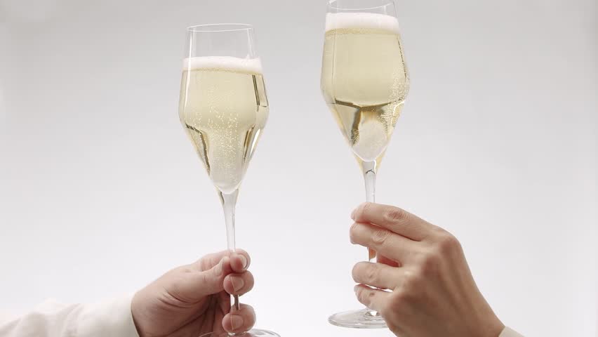 Two glasses of champagne on white isolated background, Cheers. new year celebration. Hands of happy friends cheering celebrating holidays with wine.say a toast, celebrate Christmas party with friends.