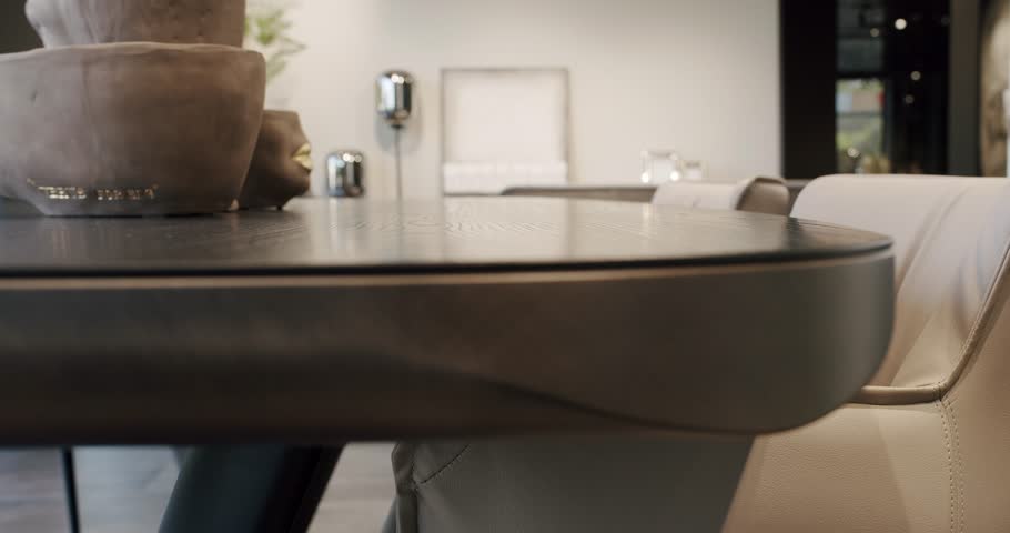 Kitchen Dining Room with wooden table and modern leater chairs. Beautiful kitchen interior with new stylish furniture. Modern Apartment. Dining Area And Lounge In Stylish And Contemporary Empty Home.