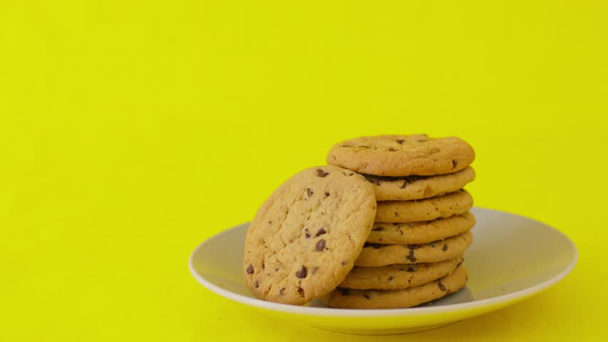A plate of cookies with a yellow background