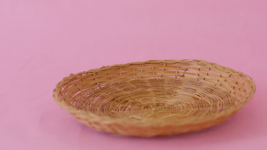 A basket of cookies is piled on top of a plate