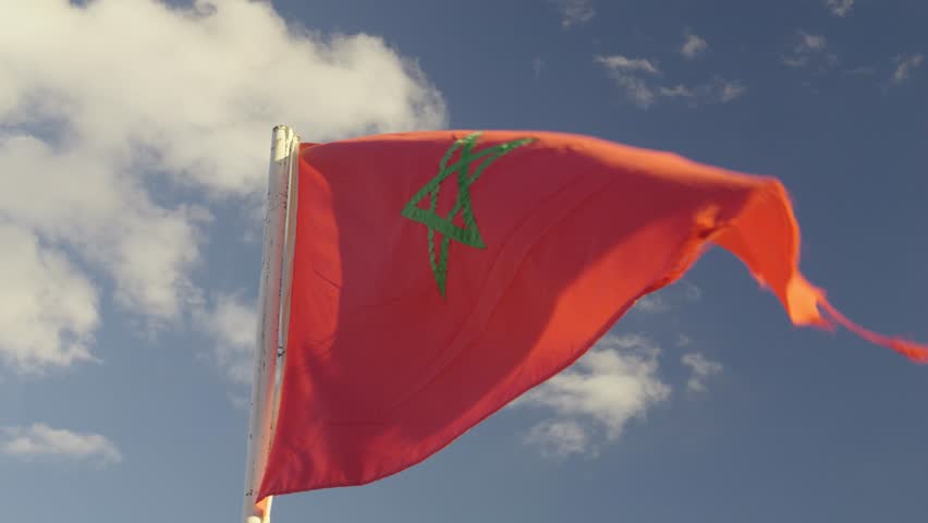 Moroccan Flag Waving Against Clear Blue Sky