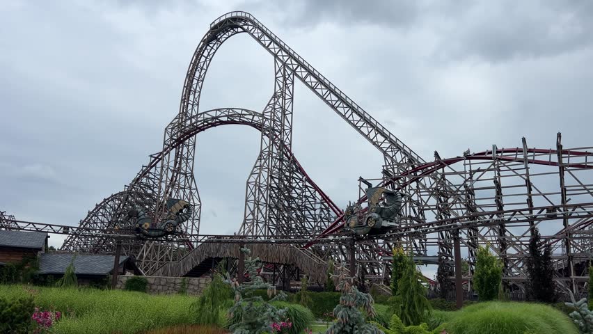 Energylandia, high-speed roller coaster climbs steep track at an amusement park